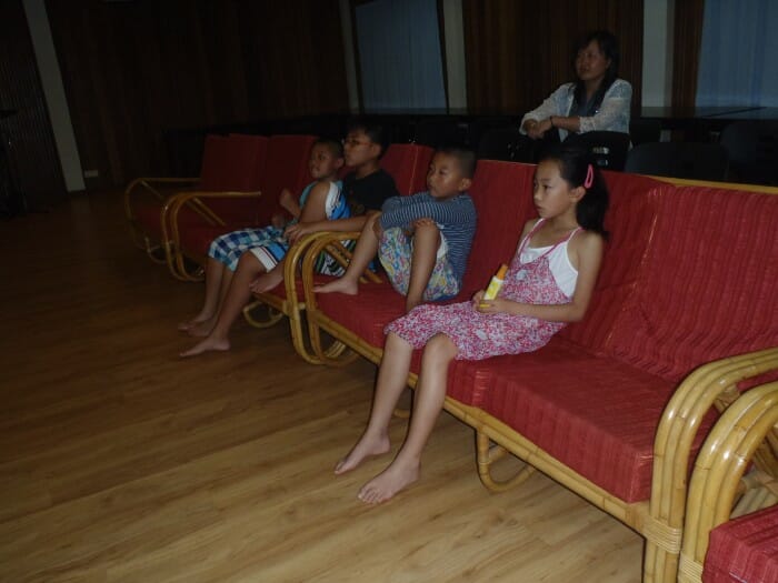 Guests relax in a comfortable sofa to enjoy the movie